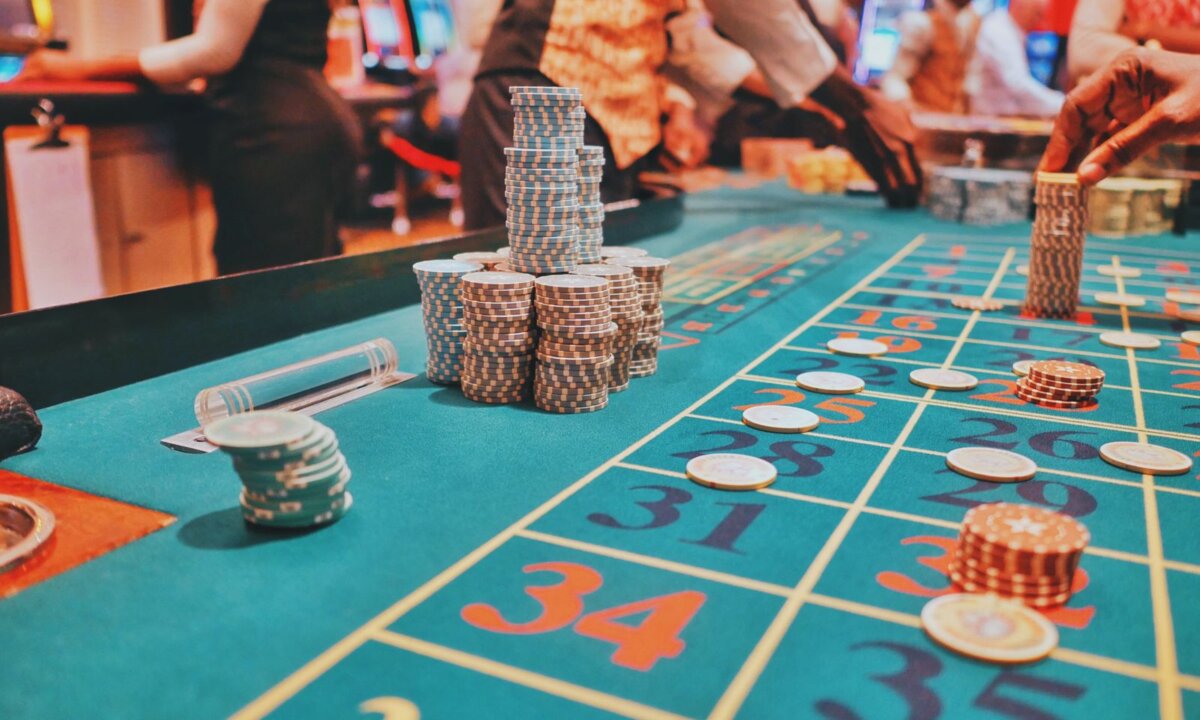 Players and chip stacks across a casino table for choosing an NZ$15 route