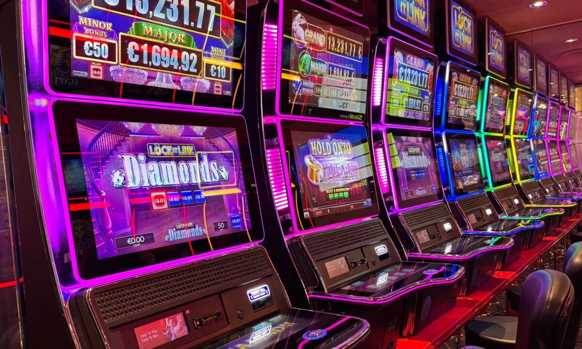 Colourful row of casino slot machines for comparing NZ$5 deposit choices