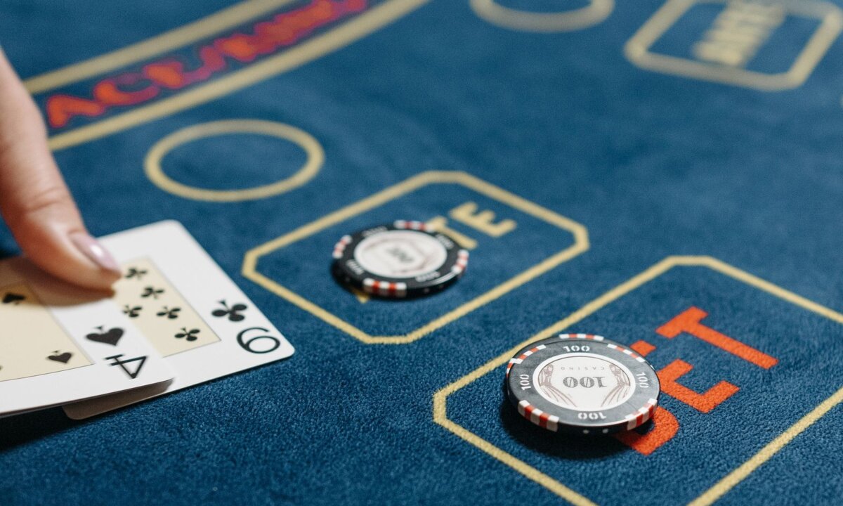 Dealt cards and casino chips on a gaming table for final NZ$5 checks